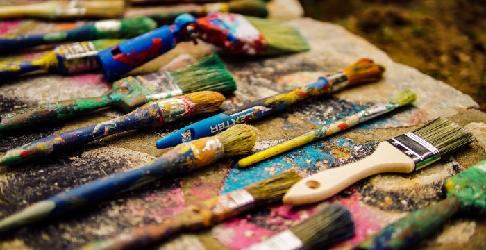 Themen und Preisträger der Jugendkunstpreise der vergangenen Jahre. Benutzte Farbpinsel liegen in einer Reihe.
